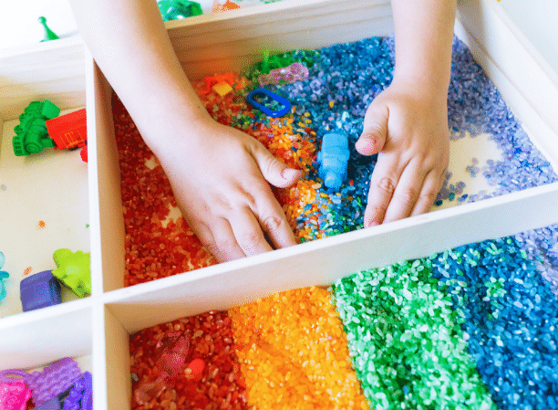 A child's hands while engaging in a colorful sensory activity